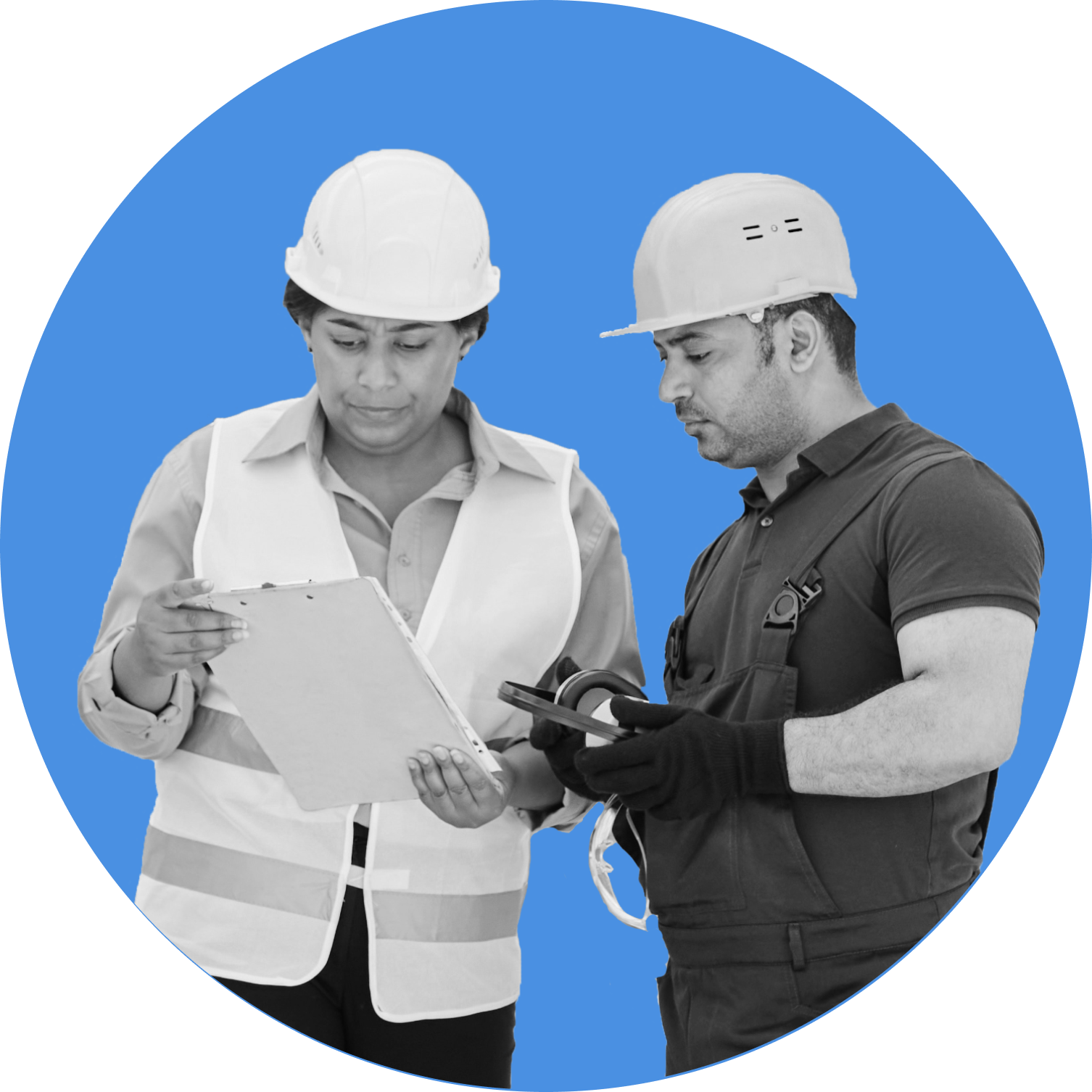 A plant worker and a manager looking at a piece of paper.