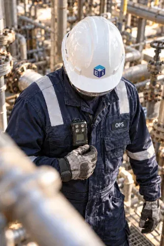 Ei crew member in full PPE with a gas monitor on the unit.